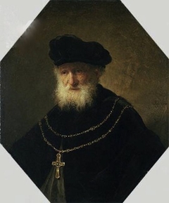 Bust of a man wearing a golden chain with a cross by Rembrandt