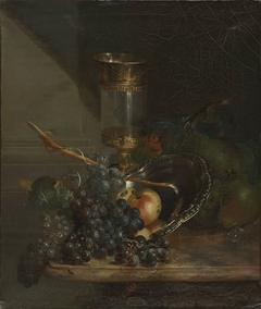 Still life with glass goblet and grapes on a marble table by Catharina Treu