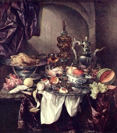 Still life with fruit, roast, silver- and glassware, porcelain and columbine cup on a dark tablecloth with white serviette by Abraham van Beijeren