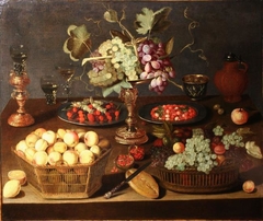 Still life with goblet holder and tazza with grapes surrounded by baskets of fruit by Artus Claessens