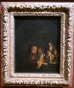 Two boys with plaster statuettes by the light of an oil lamp by Caspar Netscher