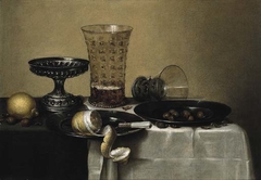 Still life with a silver tazza, a beer glass and an upturned berkemeyer by Cornelis Mahu